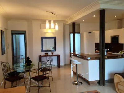 a kitchen and living room with a glass table and chairs at Appartement Cannes sur Croisette in Cannes