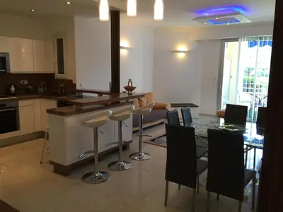 a kitchen and living room with a table and chairs at Appartement Cannes sur Croisette in Cannes