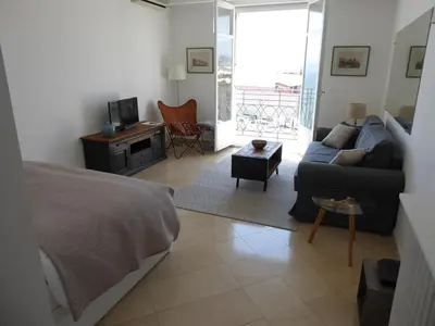 a living room with a bed and a couch at CROISETTE Palais MIRAMAR FRONT DE MER in Cannes