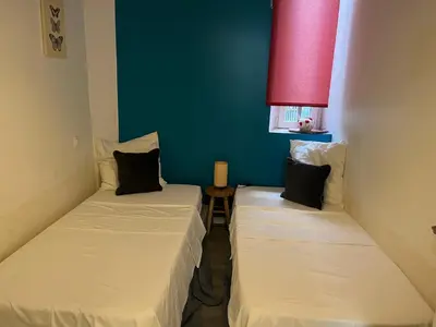 two beds in a small room with a red window at CANNES CROISETTE b in Cannes