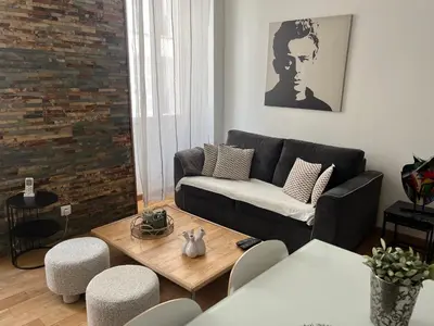 a living room with a couch and a table at CANNES CROISETTE b in Cannes