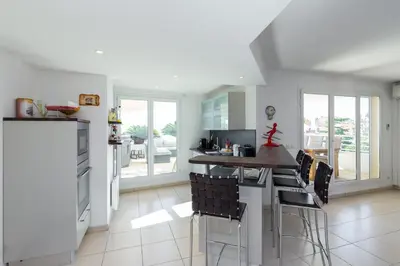 a kitchen with a counter and chairs in it at Superb penthouse in centre of Cannes Stunning views air-conditioning internet Near the Palais 532 in Cannes