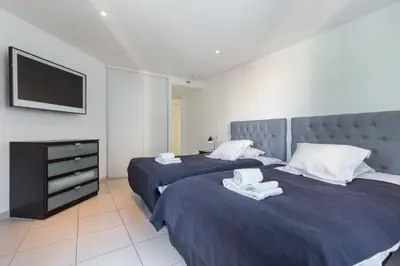 two beds in a hotel room with towels on them at Superb penthouse in centre of Cannes Stunning views air-conditioning internet Near the Palais 532 in Cannes
