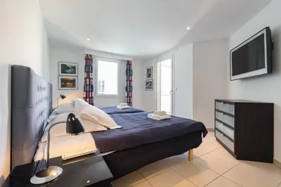 a bedroom with a large bed and a television at Superb penthouse in centre of Cannes Stunning views air-conditioning internet Near the Palais 532 in Cannes