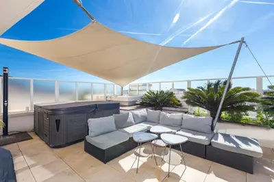 a patio with a couch and a table on a balcony at Superb penthouse in centre of Cannes Stunning views air-conditioning internet Near the Palais 532 in Cannes