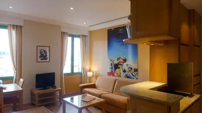 a living room with a couch and a tv at Résidences Cresci in Cannes
