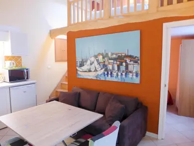 a living room with a couch and a table at Résidences Cresci in Cannes
