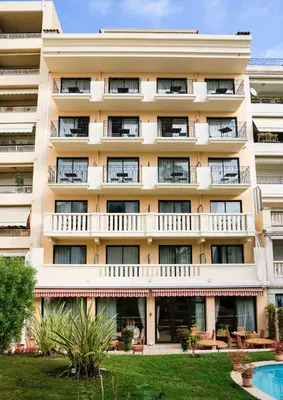 an apartment building with a pool in front of it at Sun Riviera Hotel in Cannes