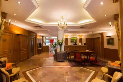 a lobby of a hotel with a table and chairs at Sun Riviera Hotel in Cannes