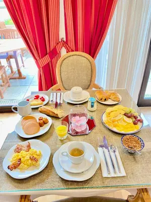 a table with plates of breakfast food on it at Sun Riviera Hotel in Cannes