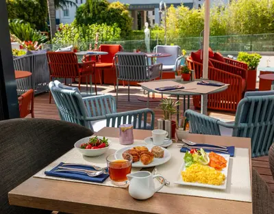 a table with breakfast food on a patio at Hôtel Le Canberra in Cannes