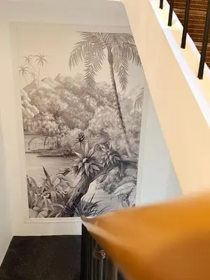 a mural of palm trees on a wall in a room at Hôtel P.L.M. in Cannes