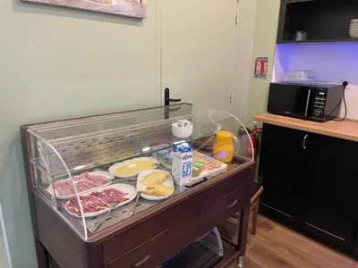 a buffet with meat and other food in a kitchen at Hôtel P.L.M. in Cannes