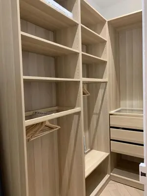 a white bedroom with a large bed and a nightstand at A 2 pas de la croisette in Cannes