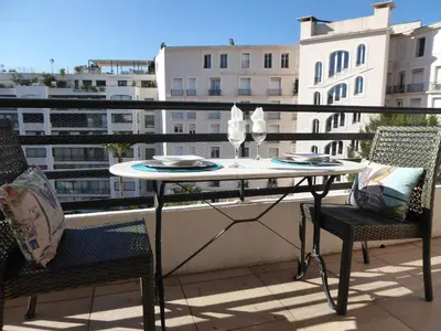 a table and chairs on a balcony with a view at Palais Rouaze in Cannes