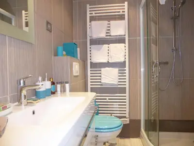 a bathroom with a sink and a toilet and a shower at Palais Rouaze in Cannes