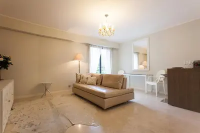 a living room with a couch and a table at Carlton Riviera Apartment in Cannes