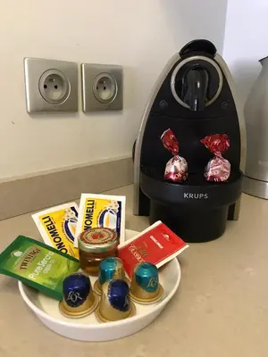 a plate of food next to a toaster at Carlton Riviera Apartment in Cannes
