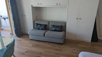 a living room with a couch and a table at Studio Vieux Port 3 étoiles in Cannes