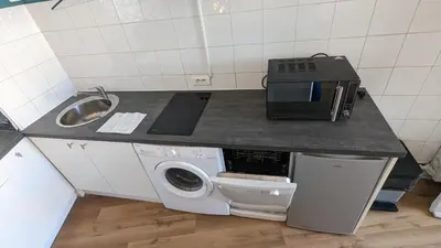 a small kitchen with a sink and a washing machine at Studio Vieux Port 3 étoiles in Cannes
