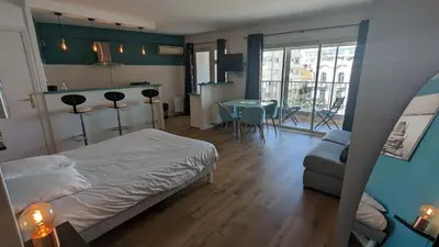 a bedroom with a bed and a table and a couch at Studio Vieux Port 3 étoiles in Cannes