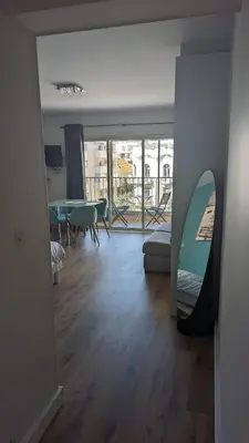 a living room with a surfboard on the wall at Studio Vieux Port 3 étoiles in Cannes