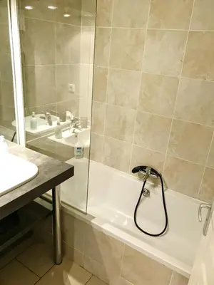 a bathroom with a shower and a tub and a sink at Duplex rénové avec balcon - Vieux Port Cannes in Cannes