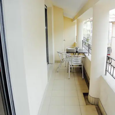 a corridor of a apartment with a table and chairs at Duplex rénové avec balcon - Vieux Port Cannes in Cannes