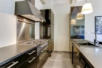 a large kitchen with a stove and a sink at Florella Félix Faure in Cannes