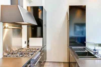 a large kitchen with a stove top oven at Florella Félix Faure in Cannes