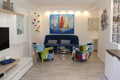 a living room with a couch and chairs at Central avec Jardin in Cannes