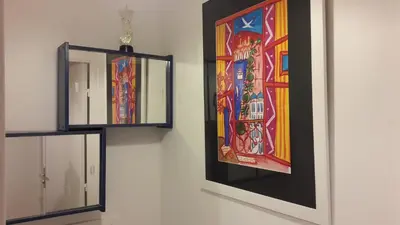 two mirrors on a wall with a painting on it at Central avec Jardin in Cannes