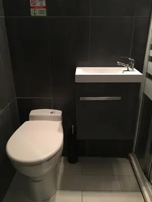 a bathroom with a white toilet and a sink at Studio Croisette Cannes in Cannes