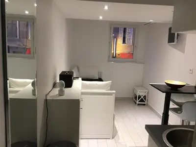 a small white kitchen with a sink and a counter at Studio Croisette Cannes in Cannes