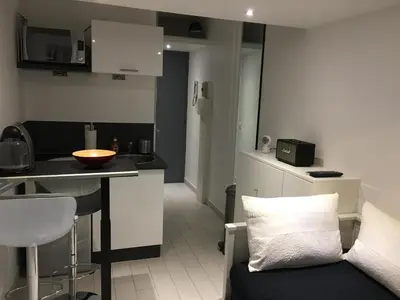 a kitchen with a couch and a table in a room at Studio Croisette Cannes in Cannes