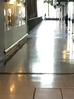 an empty hallway of a building with the light shining on the floor at Studio Croisette Cannes in Cannes
