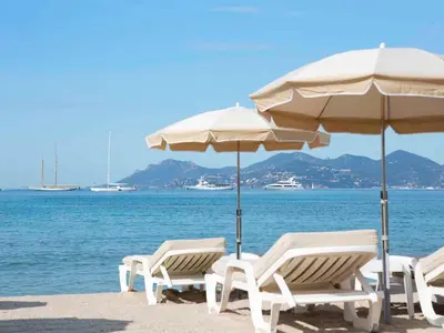 a group of chairs and umbrellas on a beach at Cannes design vue mer in Cannes