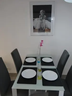 a table with white plates and a vase on it at Cannes design vue mer in Cannes