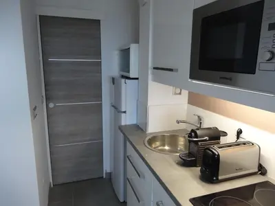 a kitchen with a sink and a microwave at Cannes design vue mer in Cannes