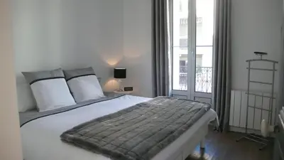 a bedroom with a large bed and a large window at Happy days, by Welcome to Cannes in Cannes