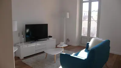 a living room with a tv and a couch and a chair at Happy days, by Welcome to Cannes in Cannes