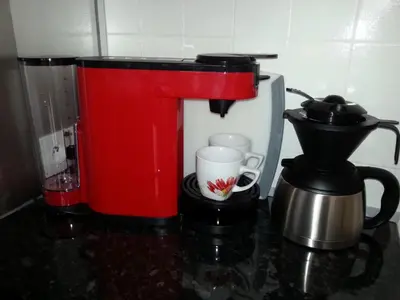 a red coffee maker and a coffee pot on a counter at Sea Side apartment in Cannes