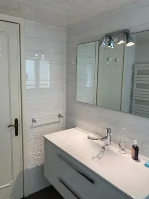 a white bathroom with a sink and a mirror at Sea Side apartment in Cannes