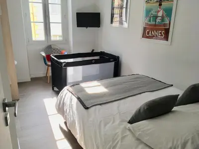 a bedroom with a bed and a desk in it at Cannes Le Chabaud in Cannes