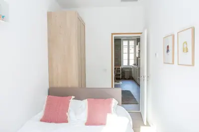 a bedroom with a bed with pink and white pillows at Cannes Le Chabaud in Cannes