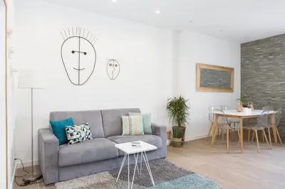 a living room with a couch and a table at Cannes Le Chabaud in Cannes