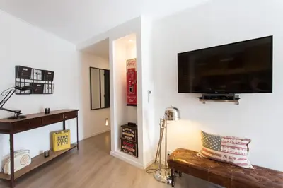 a living room with a flat screen tv on a wall at Maria Sea Cannes in Cannes