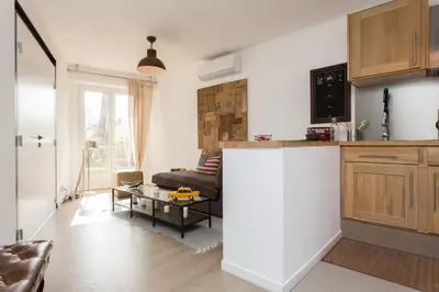 a kitchen and a living room with a couch at Maria Sea Cannes in Cannes