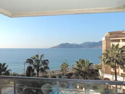 a view of the ocean from the balcony of a building at Cannes Front Beach Pools Apartment in Cannes
