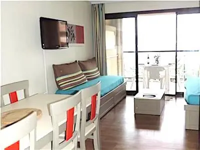 a room with a bed and a table and chairs at Cannes Front Beach Pools Apartment in Cannes